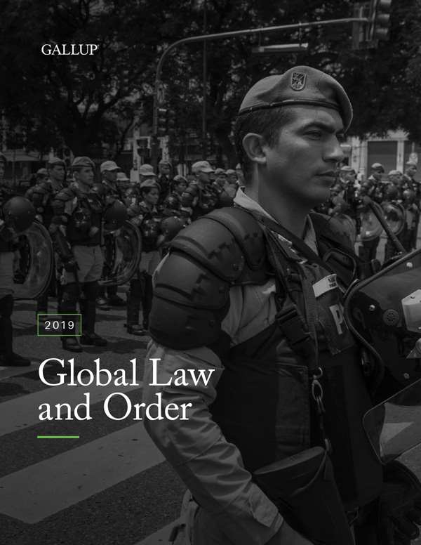 The cover of the 2019 Global Law and Order Report features a black and white image of police officer in tactical gear walking on the crosswalk on a street with many other soldiers in the background.