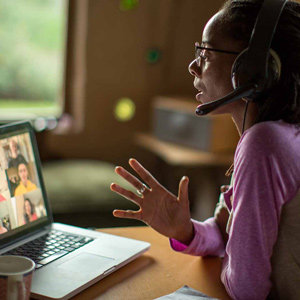 Young Black woman holding a conference call on a laptop