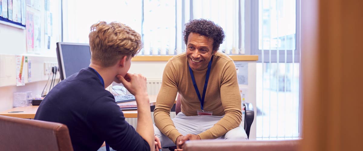 A student meeting with counselor in an office setting