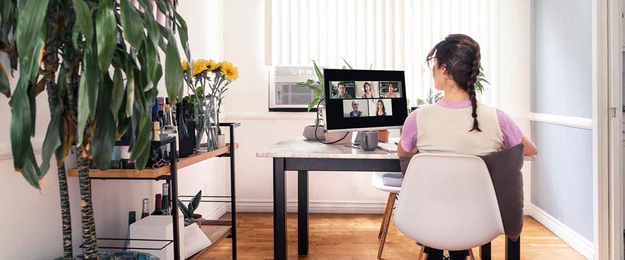 Woman working from home on a virtual call with coworkers