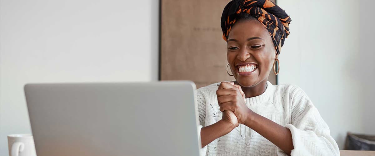 Woman smiling looking at laptop