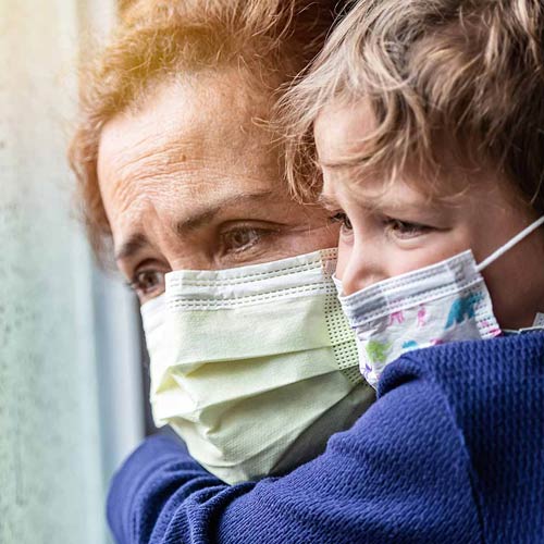 Worried woman and child wearing masks