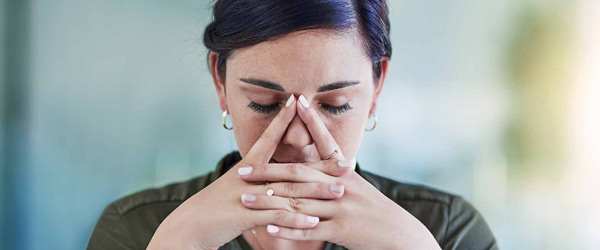 Woman with hands by her face