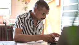 Man working on laptop at home