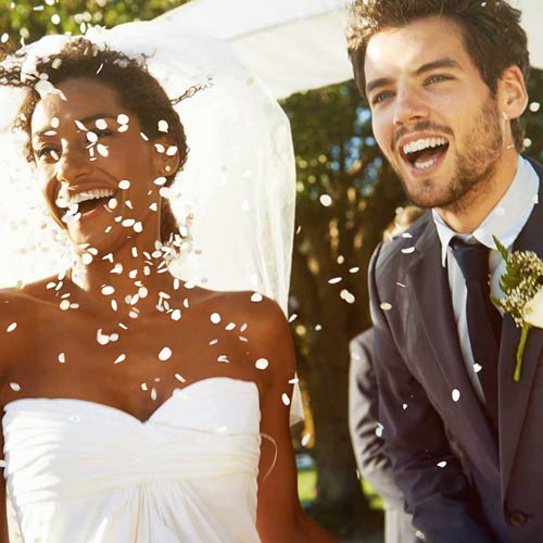 Newlyweds in a shower of confetti.